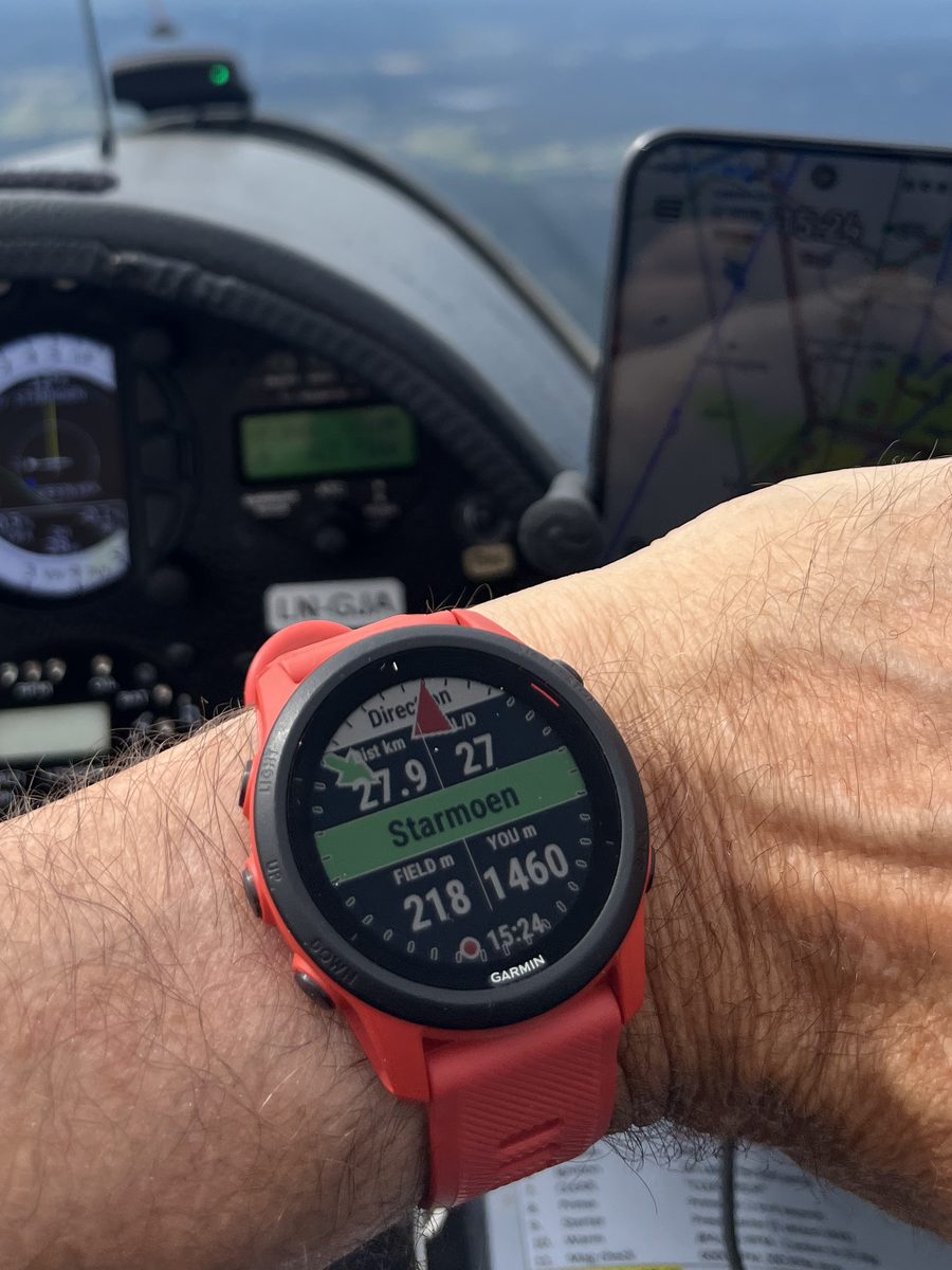 GlideRange on the wrist showing a reachable field, with the glider panel and a phone glide computer behind it.